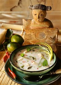 Lemon and coconut soup with fish and asparagus