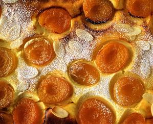 Sweet quark and apricot pudding with almonds (close-up)