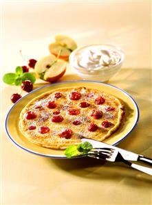 Cherry pancakes and a bowl of whipped cream