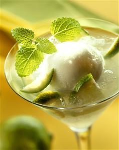 Lime & vodka drink with a scoop of lime sorbet in glass