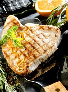 Barbecued tuna steak with herbs and orange zest