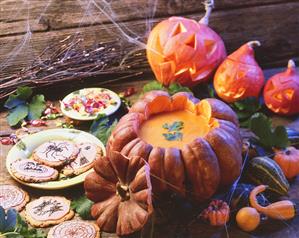 Halloween still life with pumpkin soup and cookies