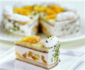 Piece of Wachau apricot gateau in front of cake with piece cut