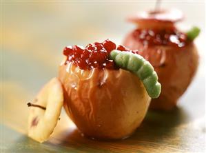 Baked apple with marzipan caterpillar