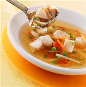 Clear fish soup with coley and vegetables