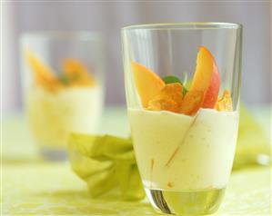 Mango yoghurt with cashew kernels and cornflakes