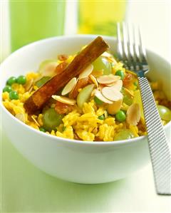 Pea pilaw with grapes, almonds and cinnamon stick