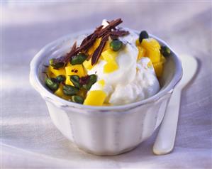 Mango quark with pistachios and chocolate curls