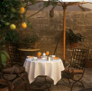 Laid table with melon and tea service