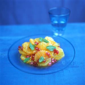 Orange salad with pomegranate in blue light