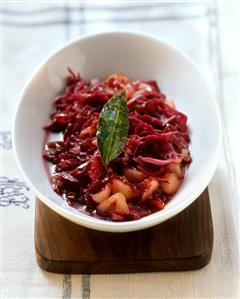 Apple and red cabbage on white platter