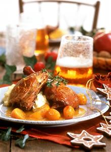 Goose leg with mashed potato and citrus fruits