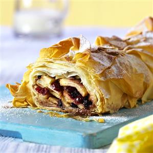 Sweet strudel with fruity filling, a piece cut