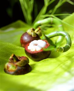 Mangosteens, green background