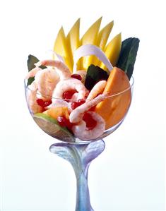 Prawn salad with exotic fruit in cocktail glass