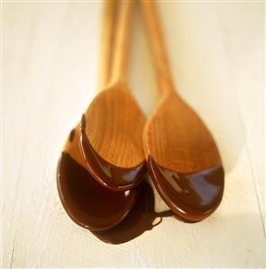 Melted chocolate on kitchen spoons