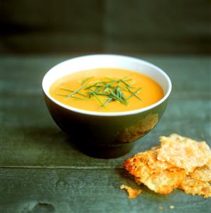 Creamed carrot soup with chives in small bowl