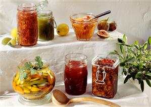 Six jars of spicy fruit preserves and chutneys