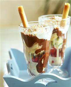 2 ice cream sundaes with fruit, chocolate sauce & hollow wafer