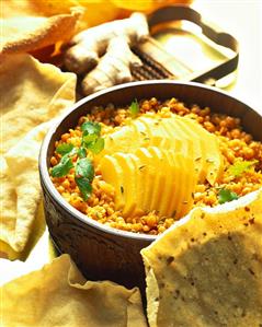 Red lentils with slices of mango, with poppadoms (India)