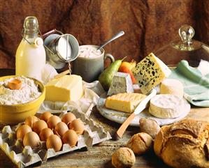 Still life with dairy products, eggs, bread, flour and fruit