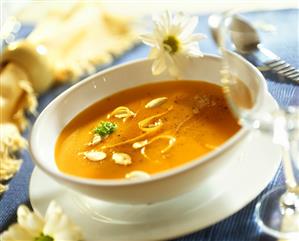 Pumpkin soup with strips of pumpkin and pumpkin seeds