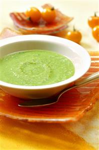 Creamed pea soup on orange service plate