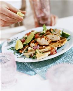 Grilled chicken breast on flatbread with diced vegetables