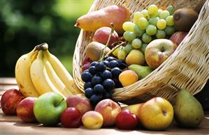 Various fruits in and in front of basket