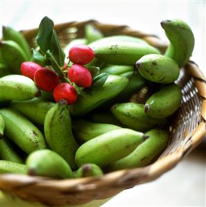 Green bananas and red almond fruits