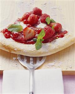 A piece of berry pizza (yeast cake with berries)