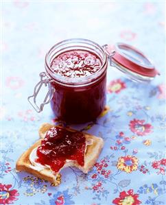 Strawberry jam on toast and in preserving jar