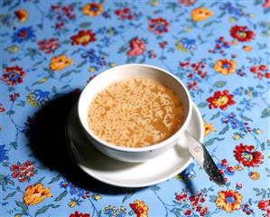 Bowl of alphabet soup, child's spoon