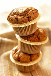 Three chocolate muffins on top of each other