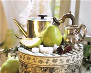 Still life with pears, sugar cubes and silver jugs