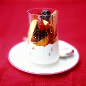 Creamy yoghurt with fruit and honey in a glass