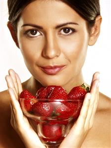 Woman holding a bowl of strawberries