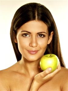 Woman holding a green apple