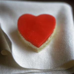 Heart-shaped sponge cake with red icing