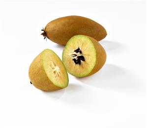 Whole and halve sapodilla (the fruit of the sapodilla tree)