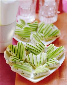 White bread hearts with soft cheese & cucumber slices for party