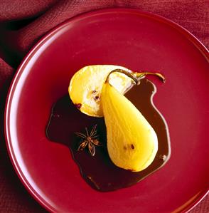 Poached pear halves with chocolate sauce