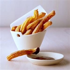 Churros with chocolate dip (fried dough strips, Spain & Mexico). Receta disponible TR.