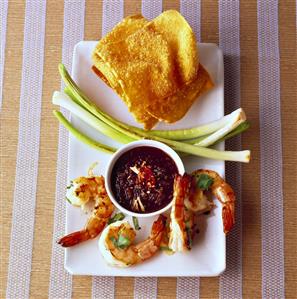 Shrimps with chocolate dip and deep-fried wonton sheets