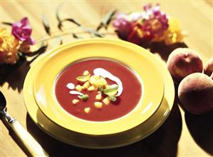 Tomato soup with peach, basil and crème double