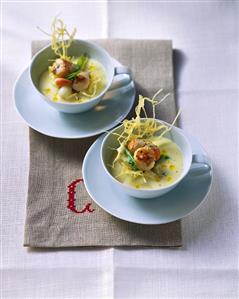 Two dishes of potato soup with scallops