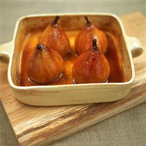 Four baked pears with honey in baking dish