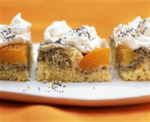 Three pieces of apricot with poppy seeds and cream