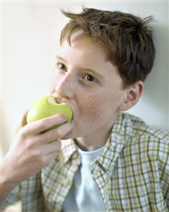 Boy biting into an apple