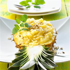 Pineapple rice with nuts in a pineapple half (Thailand)